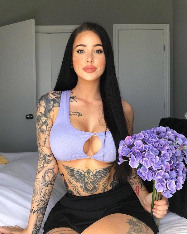 Tattoed girl with boobs playing