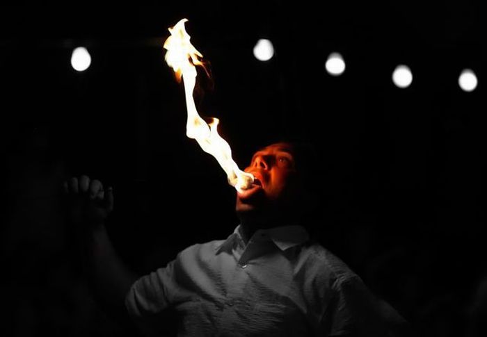 человек играющий с огнем. дыхание огня. мужчина в огне. интерактив с огнем. подуть на огонь.