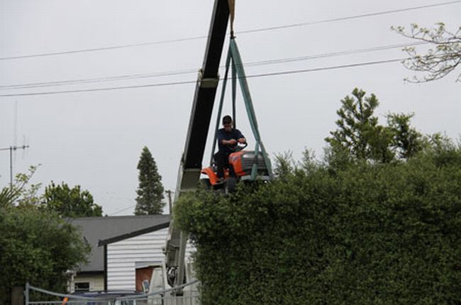 Man Uses Mower Attached to Crane to Trim Hedge (4 pics)