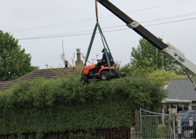 Man Uses Mower Attached to Crane to Trim Hedge (4 pics)