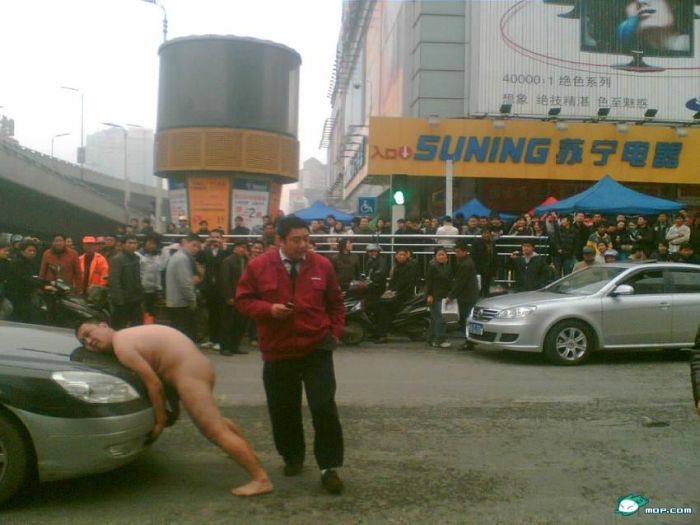 A Crazy Naked Man Trying to Lift a Taxi (23 pics)