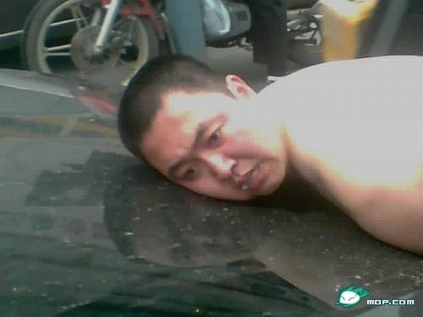 A Crazy Naked Man Trying to Lift a Taxi (23 pics)