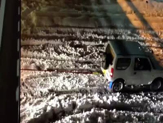 Miniature Suzuki SUV WIN on Snowy Road