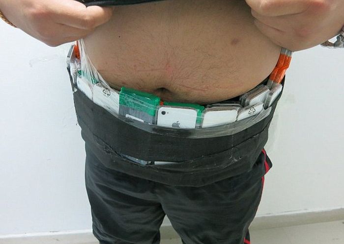 Smuggler Gets Busted With 146 iPhones Taped To His Body (3 pics)