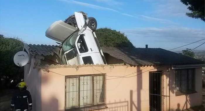 Car Lands Engine First In The Roof Of A House (3 pics)