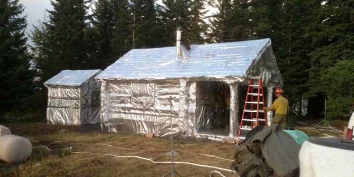 Buildings Wrapped In Tin Foil To Protect Them From Wildfires (3 pics)