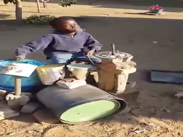 Boy Playing On Makeshift Drums