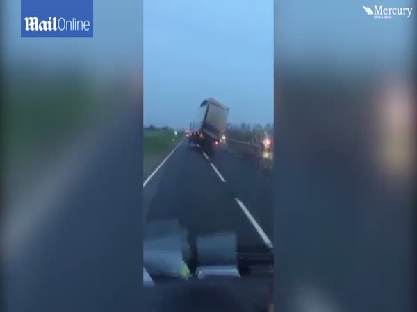 High Winds Blow Lorry On To Two Wheels As It Drives Along Motorway While Teetering At 45 Degrees