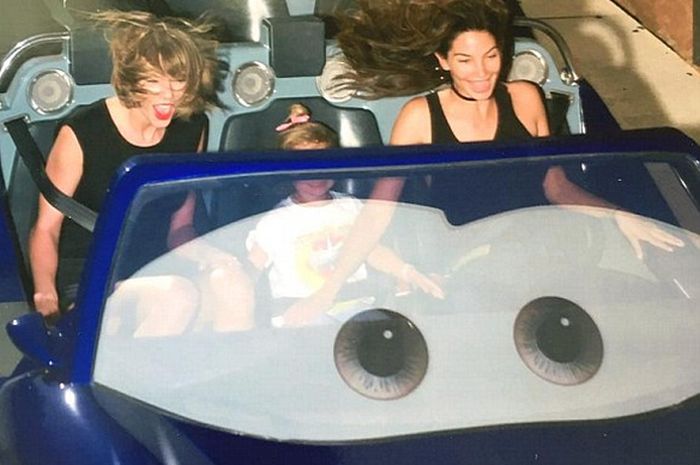 Taylor Swift's Bodyguard Is Not Impressed By Disneyland (2 pics)