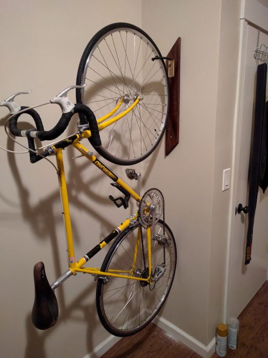 Guy Creates An Awesome Bike Rack With Two Pieces Of Wood And A Hook (7 pics)