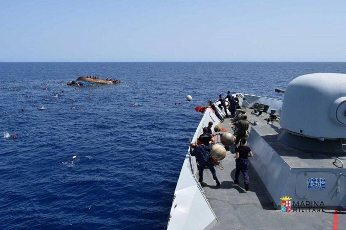 Italian Navy Rescues Migrants After Their Boat Reaches A Tipping Point (8 pics)