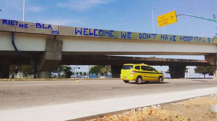 Citizens Of Rio Greet Visitors With A Welcome To Hell Banner (2 pics)