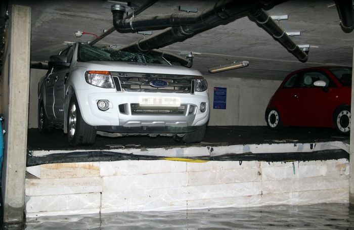 Cars Get Crushed After Pipe Bursts In Parking Garage (4 pics)