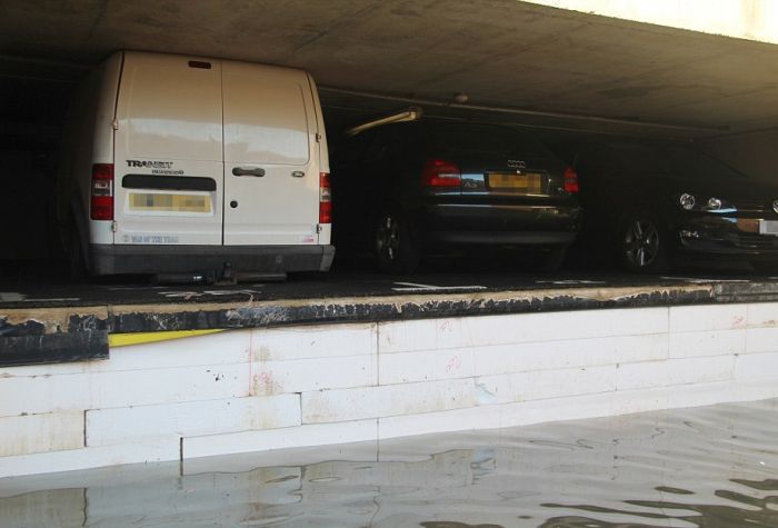 Cars Get Crushed After Pipe Bursts In Parking Garage (4 pics)