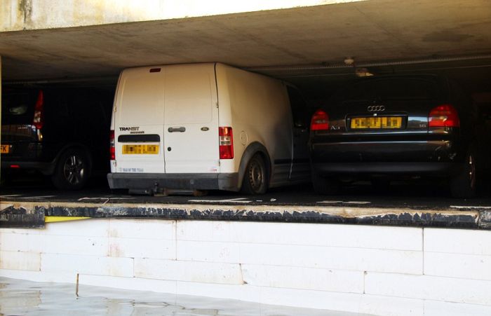 Cars Get Crushed After Pipe Bursts In Parking Garage (4 pics)