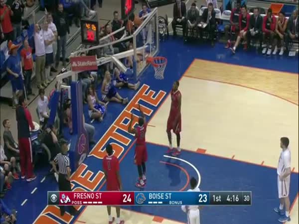 Watch a brave young fan climb above the rim to free basketball stuck behind backboard