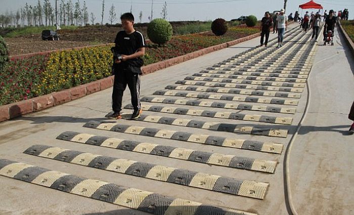 Chinese Tourist Attraction Adds Ridiculous Speed Bumps For Pedestrians (5 pics)