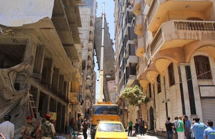 High Rise Building Falls Into A House In Egypt (6 pics)