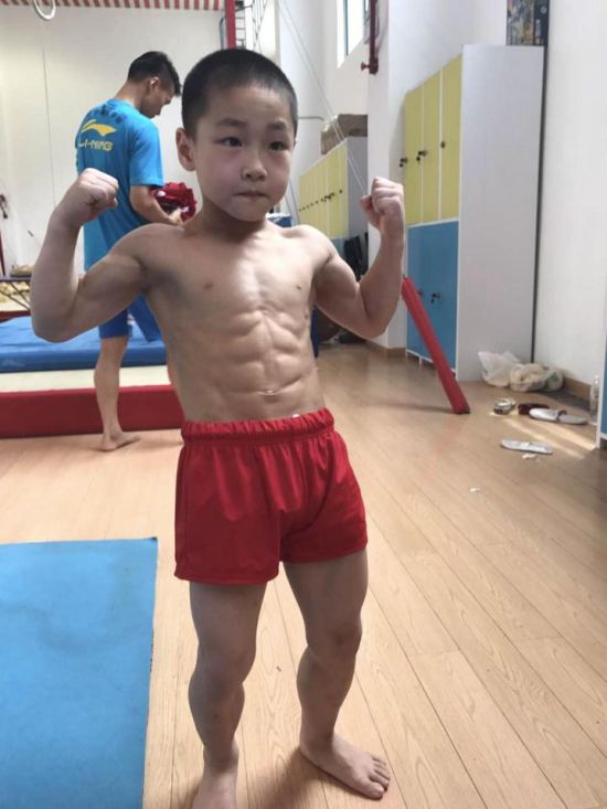 Seven Year Old Chinese Kid Shows Off His Eight Pack After Winning Medals (4 pics)