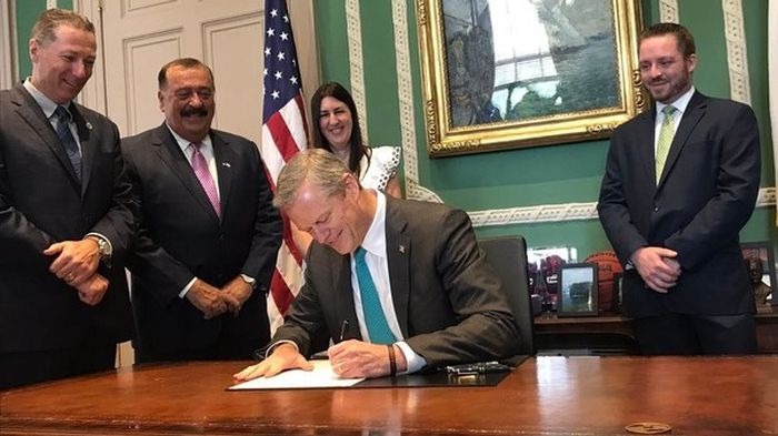 The Governor Of Massachusetts Smiles As He Signs Off On New Law (3 pics)
