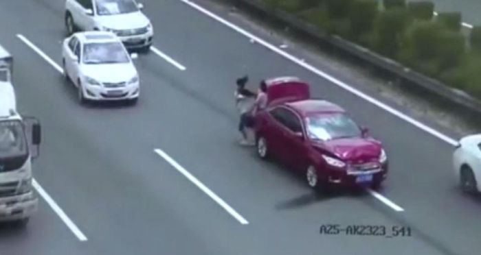 Couple Holding Baby Almost Get Killed By Oncoming Car (5 pics)