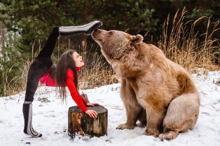 Gymnast Poses With A Brown Bear (5 pics)