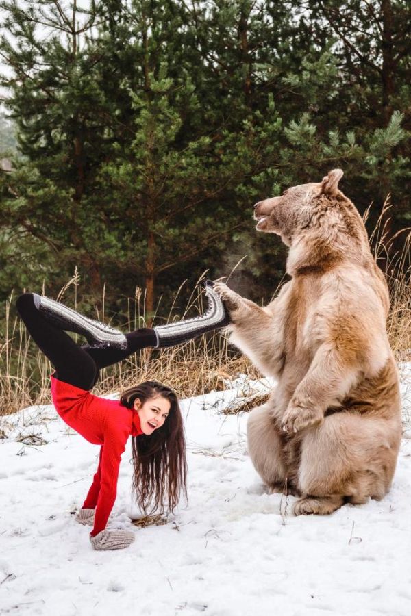 Gymnast Poses With A Brown Bear (5 pics)