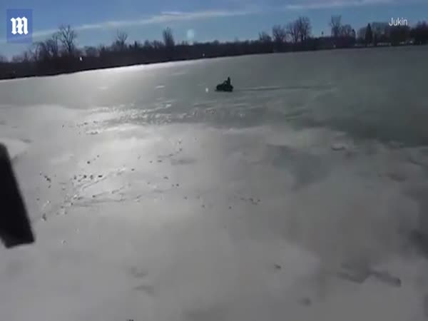 Drone captures: Snowmobiler Clings to Ice After Falling Through Frozen Pond