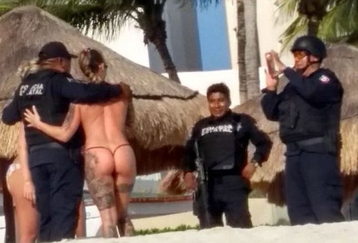 Cancun Cops Are Suspended After Posing With Topless Tourists (3 pics)