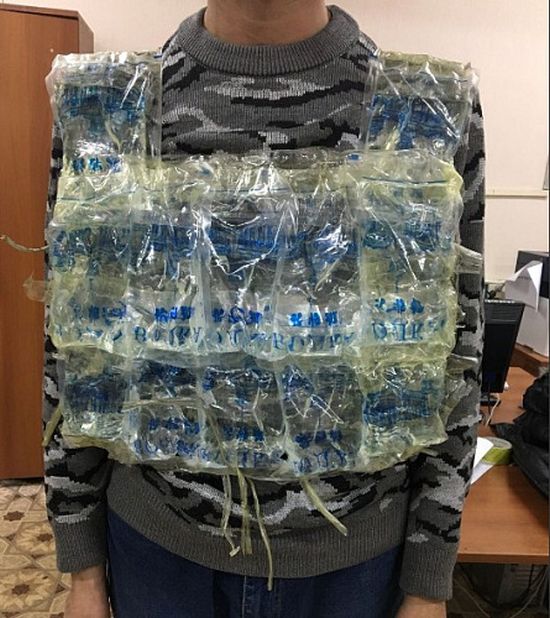 Man Tries To Smuggle 12 Litres of Vodka Into Russia (3 pics)