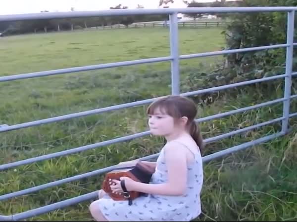 Little Girl Serenades Herd of Cows